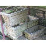 Four reclaimed garden planters comprising a pair of square cut form with simulated stone wall façade