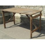 Three vintage pine folding trestle tables, the top 136cm x 69cm