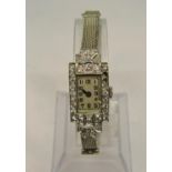 Art Deco ladies platinum and diamond set cocktail watch, the stylised case with rectangular dial
