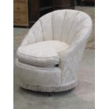 A low cream ground floral upholstered bedroom/occasional chair with fan/shell shaped back, loose