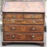 An 18th century walnut veneered and stained pine sided bureau with inlaid chevron banding, the