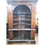 A substantial Georgian oak alcove cupboard with barrelled back fitted with shaped and open