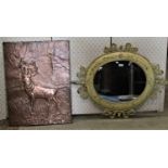 A contemporary oval painted and distressed metal framed wall mirror with scrolling acanthus detail