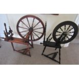 A traditional foot pedal operated spinning wheel principally in stained pine with ring and bobbin