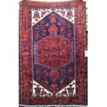 Good quality Persian full pile rug with central red medallion with blue borders with various