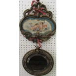 A 19th century continental ceramic plaque of shaped form with painted decoration of cherubs dressing