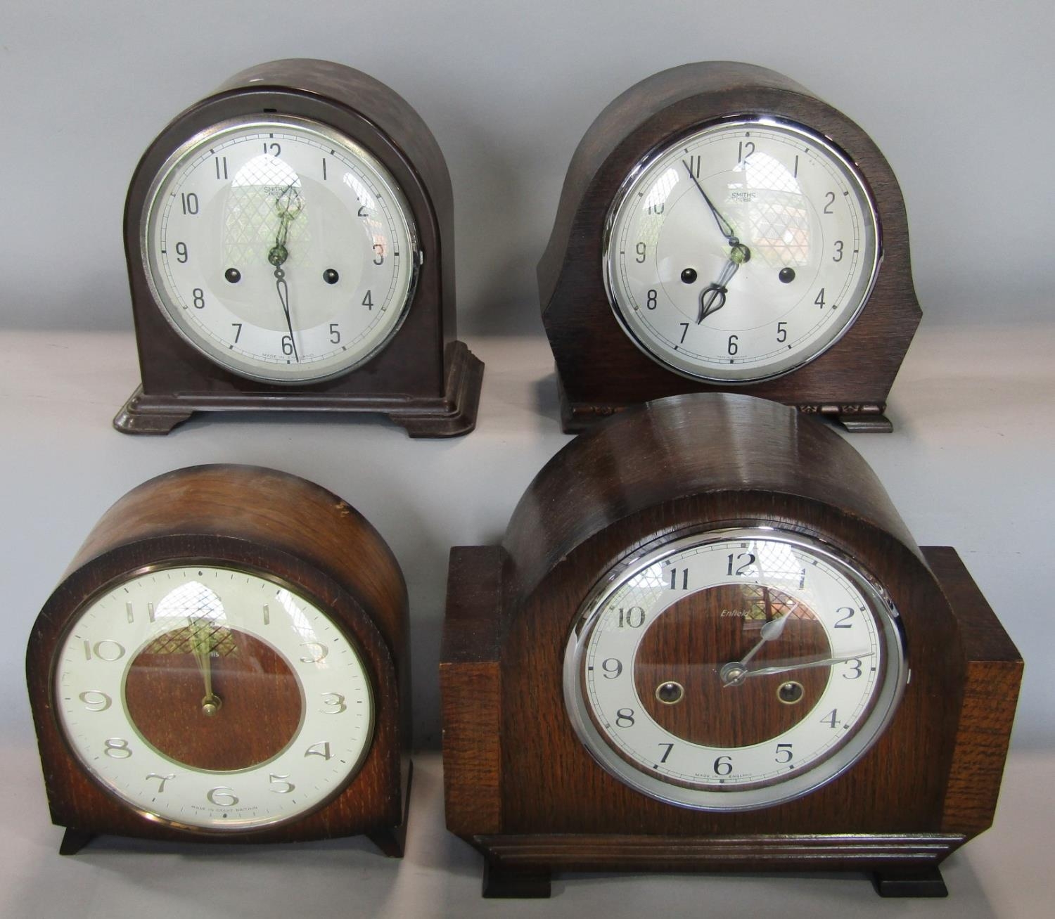 Three Smith two train vintage mantle clocks, one in bakelite together with a similar Enfield example