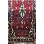 Full pile Mahal runner with white medallion and foliate decoration upon a washed red ground, 375 x