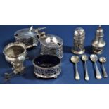 A collection of silver cruet items comprising two lidded mustards, salt, all with pierced sides