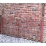 A pair of iron work driveway entrance gates of stepped arched form with vertical square and