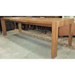 A contemporary light oak and veneered pull out extending dining table of rectangular form with two