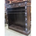 A Victorian gothic dark stained oak freestanding open bookcase partially fitted with two frieze