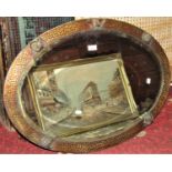A 1920s/30s oval wall mirror with bevelled edge plate within an anodised frame with applied