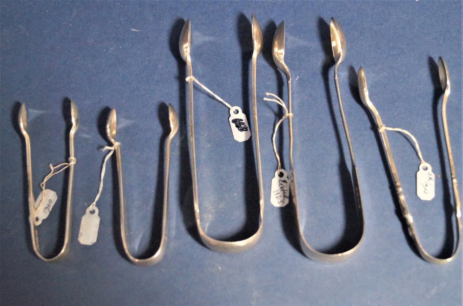 Five antique and later silver sugar tongs together with two further silver mustard spoon and a - Image 2 of 4
