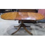 A good quality Regency style yew wood veneered D end extending dining table with single additional