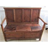 A Georgian period countrymade box settle in mixed woods including elm and pine, with rising lid
