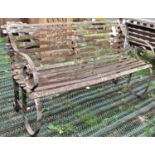 An old heavy gauge sprung steel garden bench with strapwork seat and combined back, 153cm long (