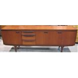 A Greaves & Thomas long and low teak sideboard enclosed by three doors and tower of three drawers,