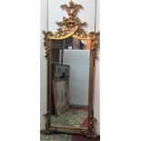 An antique style wall mirror with gilt scrolling acanthus and moulded frame, 150 cm x 65 cm