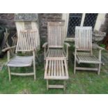 A pair of weathered teak folding steamer type chairs with slatted seats, backs and foot rests,