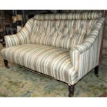 An Edwardian two seat drawing room/parlour sofa with rolled arms, shaped outline and later