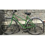 A vintage Motobecane 10 speed touring bicycle, with swept back handlebars and tubular green