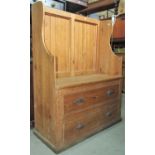 A reclaimed stripped pine winged settle with tongue and groove panelled back over a solid seat and