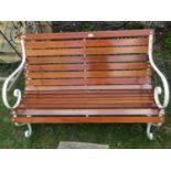 A cream painted, sprung steel framed, two seat garden bench with hardwood varnished lathes, 122cm (4