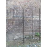 A pair of contemporary decorative light metal garden screens with scrollwork detail, 70 cm wide x