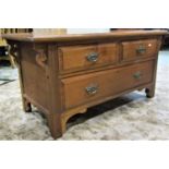 A low Edwardian walnut chest of one long and two short drawers with moulded detail and overhanging