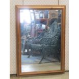 A Victorian walnut veneered chimney glass with inlaid straw work banded detail, raised on ceramic