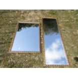 Two similar contemporary gilt framed wall mirrors of rectangular form, with repeating scrolling