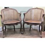 A pair of 19th century bergere armchairs, with carved and moulded framework on shaped supports