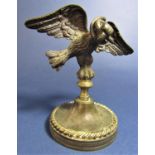 A 19th century bronze in the form of an eagle wings outstretched with a snake wrapped around its