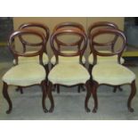 A set of six Victorian mahogany balloon back dining chairs, with recently reupholstered seats,