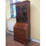 An Edwardian mahogany bureau bookcase, the bureau of four long drawers, the fall flap enclosing a