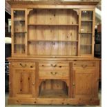 A pine kitchen dresser, the base fitted with four frieze drawers and two cupboards flanking a