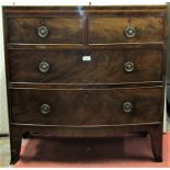 A small Georgian mahogany and oak lined bowfronted chest of two long and two short drawers, with