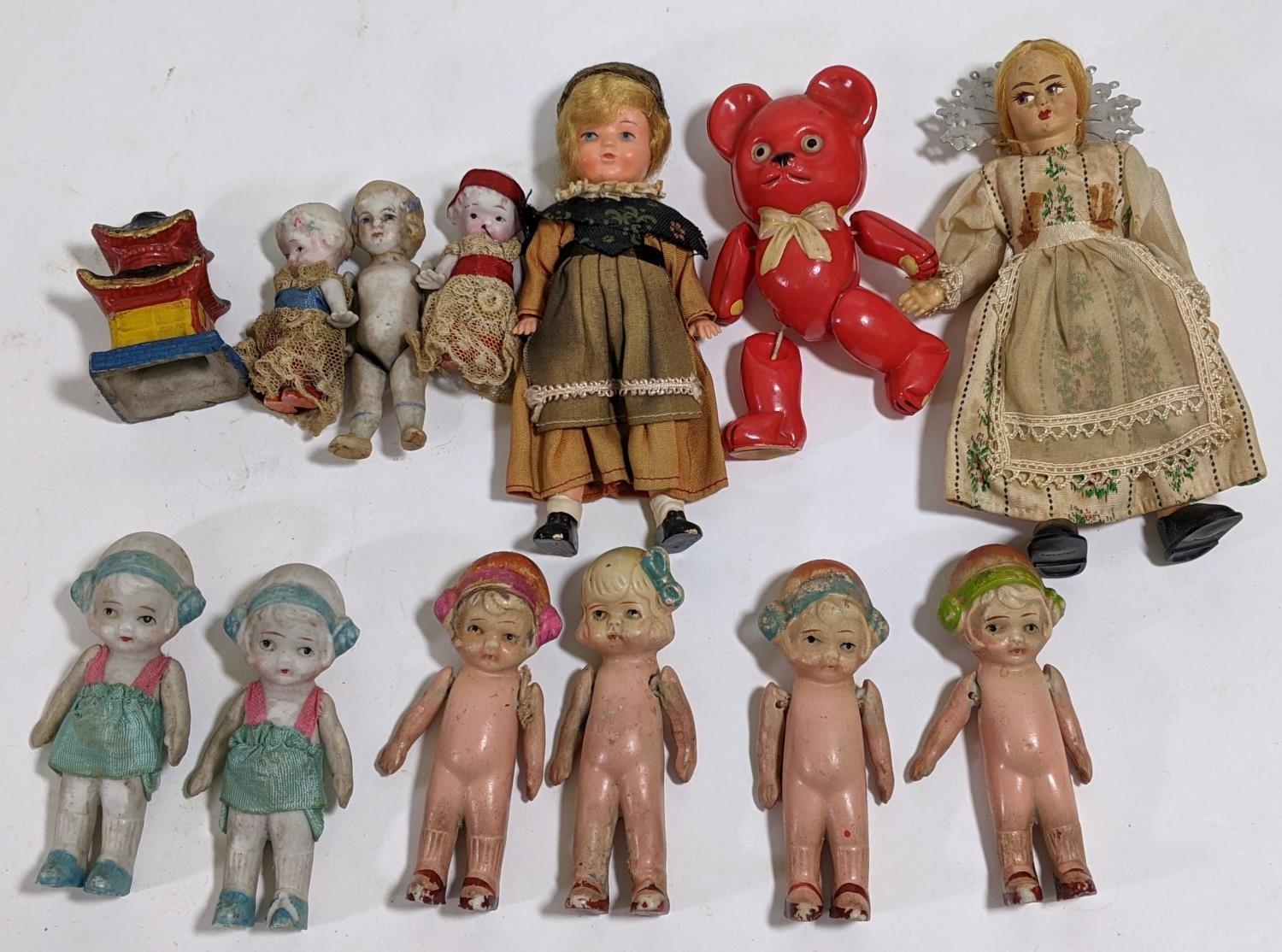 9 miniature bisque dolls, C1920's, most styled as Flapper girls, height 6-9cm, together with a small