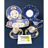 A collection of 19th century dessert wares with reserved floral panels on a blue ground,