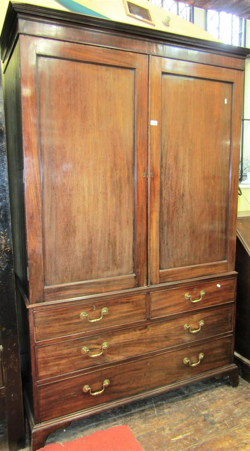 A Georgian mahogany linen press, enclosed by two long and two short graduated drawers, the upper