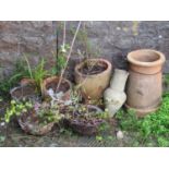 A reclaimed buff coloured chimney pot of cylindrical flared form together with two small