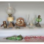 A late Victorian oil lamp with ironwork base, ceramic font and etched glass globe and one another, a