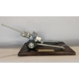 Trench Art Interest - A model of a field gun set on an oak base, dated 1960, 45cm long overall