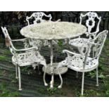 A cast aluminium garden terrace table with decorative pierced circular foliate top raised on