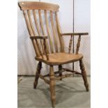 A Windsor beechwood lathe back armchair raised on turned supports and stretchers