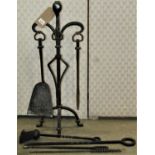An Arts & Crafts style iron work companion set together with four further fire tools