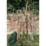 A small quantity of long handled gardening tools, together with two rolls of coated garden edging