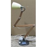 An industrial style articulated wooden desk/bench lamp with conical shade and swept cast metal base