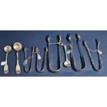 Five antique and later silver sugar tongs together with two further silver mustard spoon and a